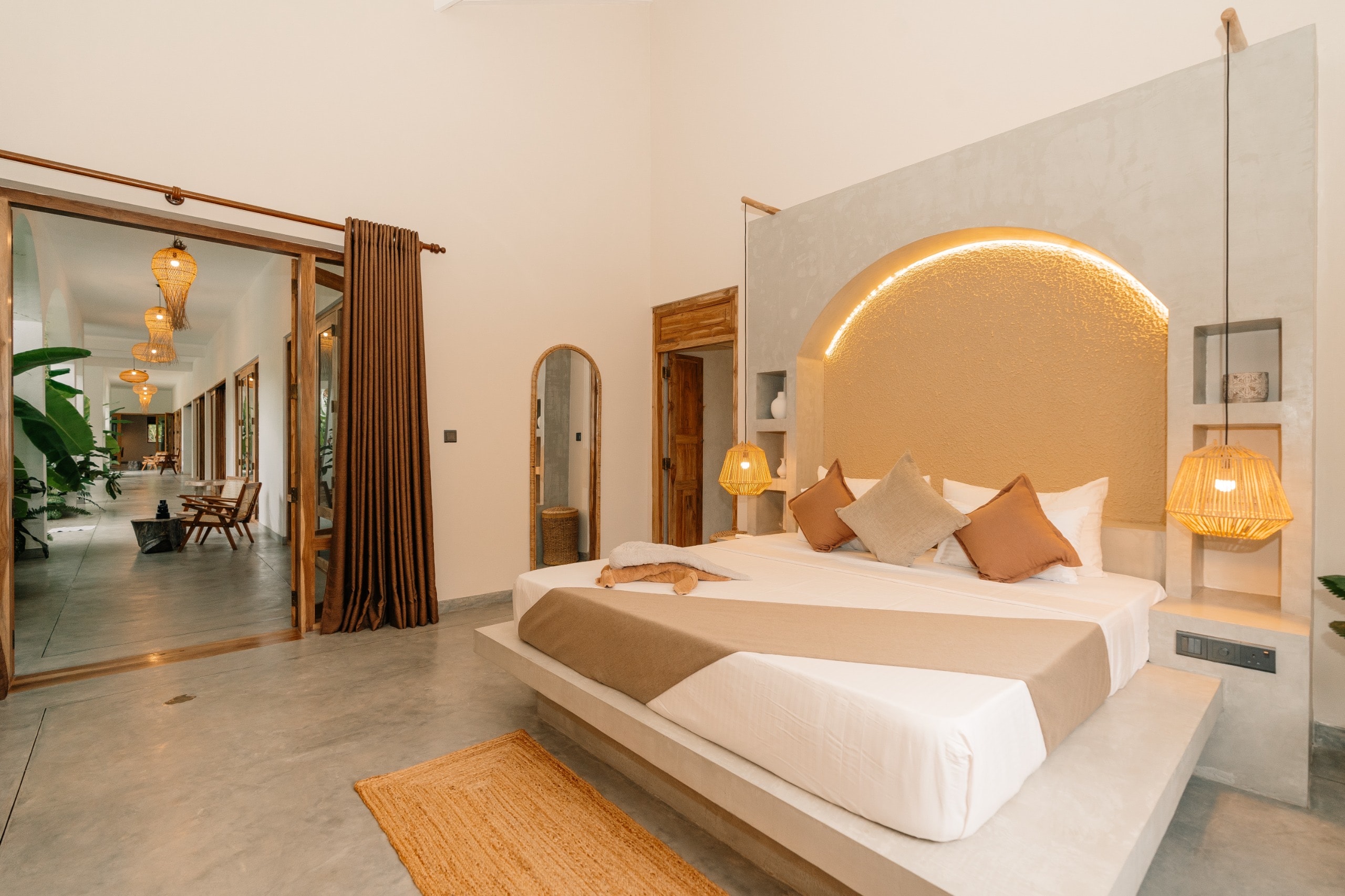 King bedroom with arched glowing headboard at Villa Oura Spirit